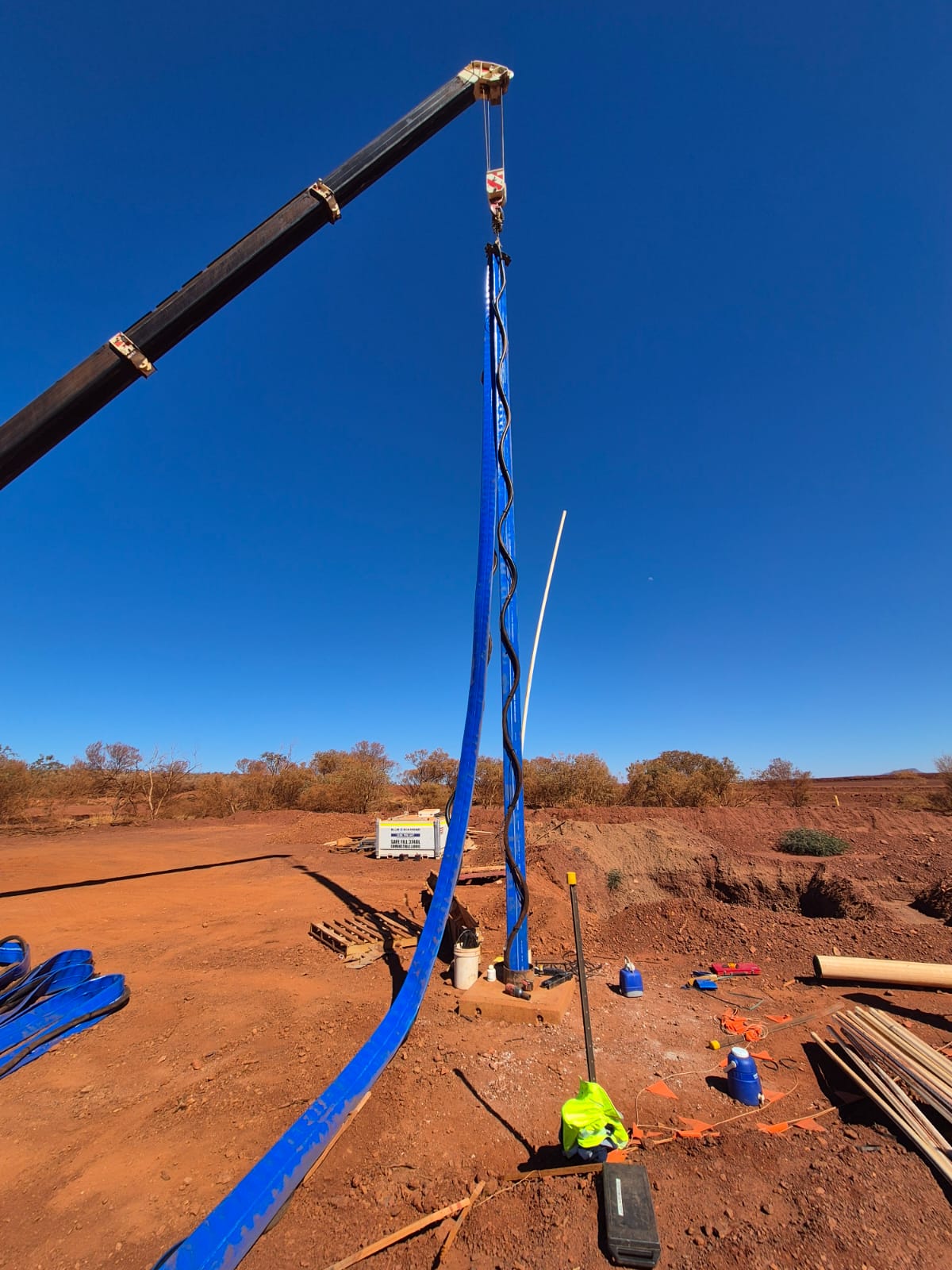 Crane handling a discharge pipeline beside the dewatering generator