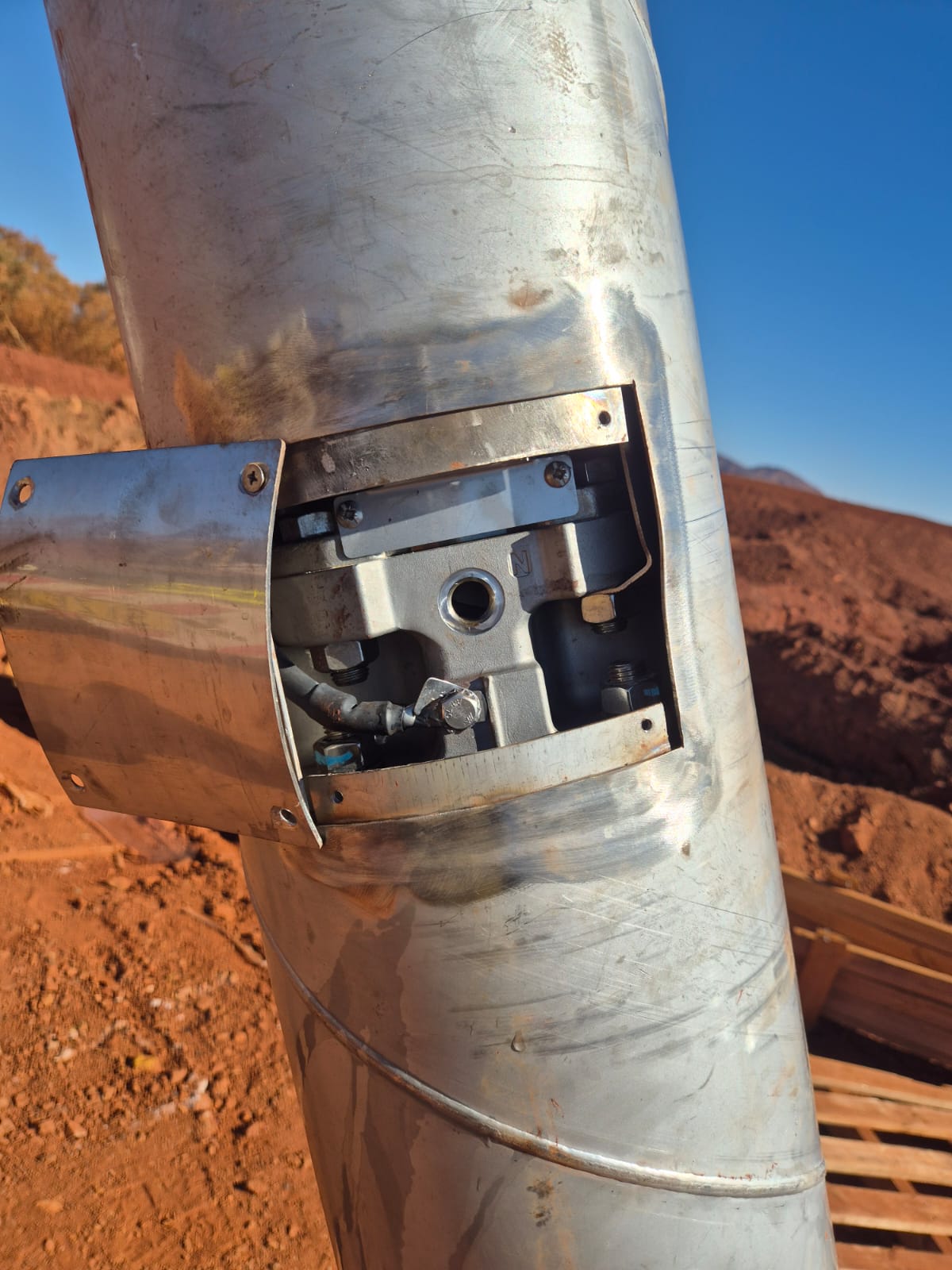 Crane lifting a pump riser and discharge hose on a dewatering bore