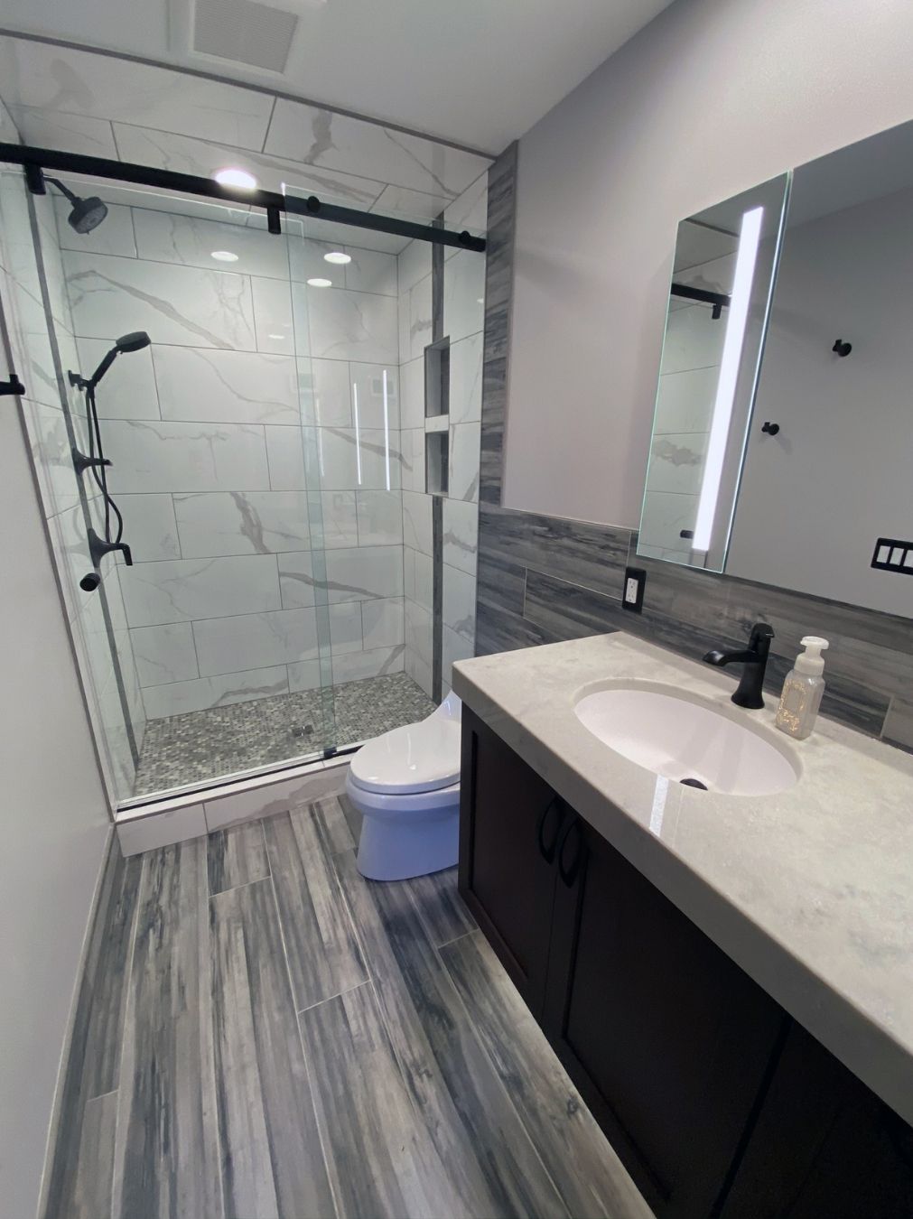 Completed vanity with twin basins and illuminated mirror