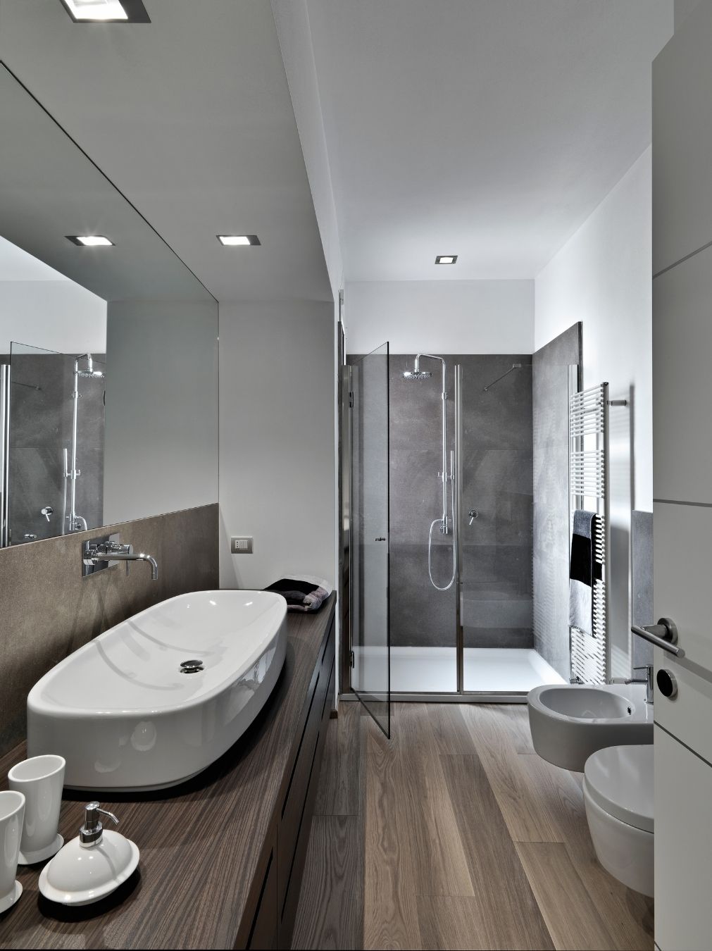 Renovated bathroom with white vanity and full tiling